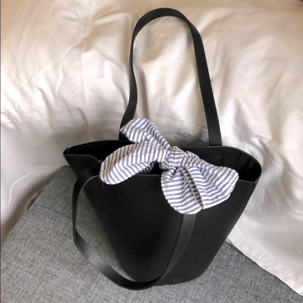 Round bottom black tote bag.